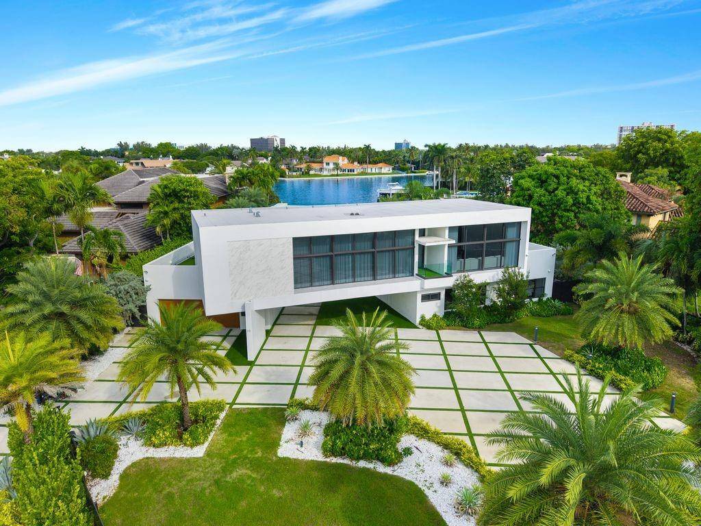 Magnificent waterfront estate in Sea Ranch Lakes, a gated home within the exclusive 24 hr guard gated community with private beach club.