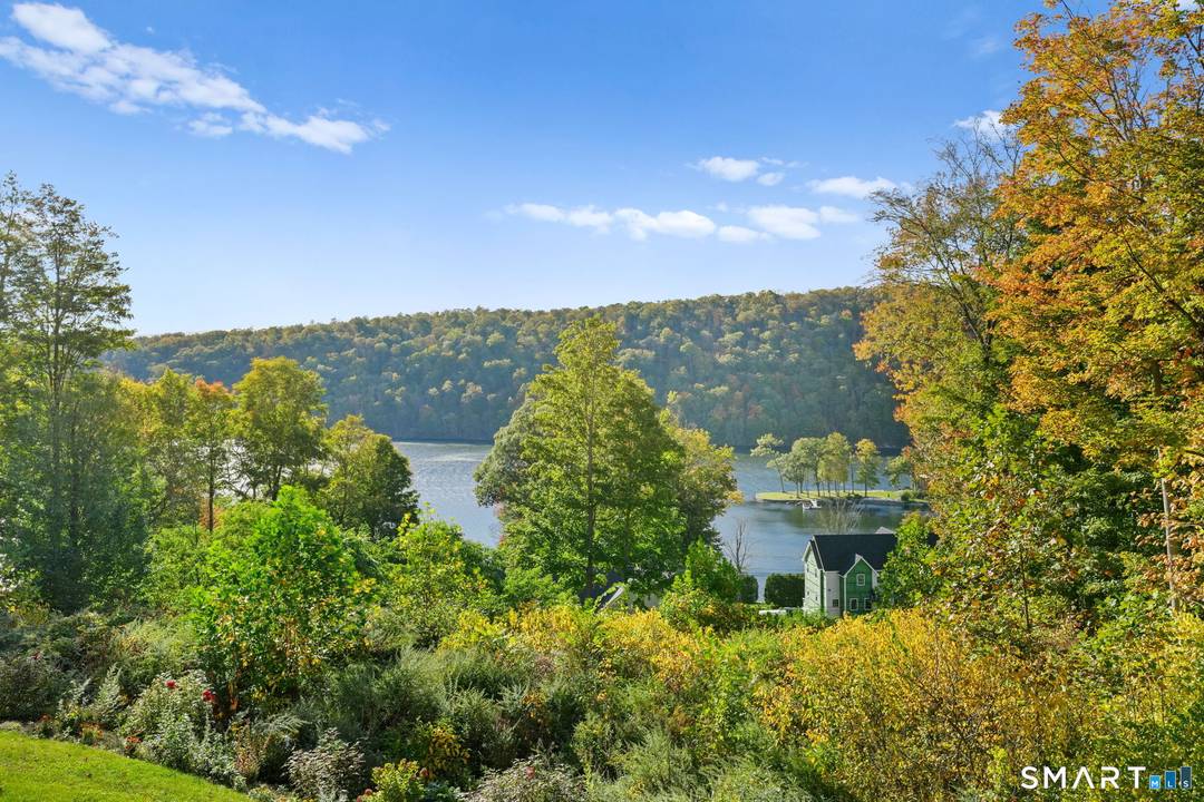 Experience classic New England charm in this beautiful colonial nestled at the bottom of a hill, offering gorgeous lake views from nearly every room.