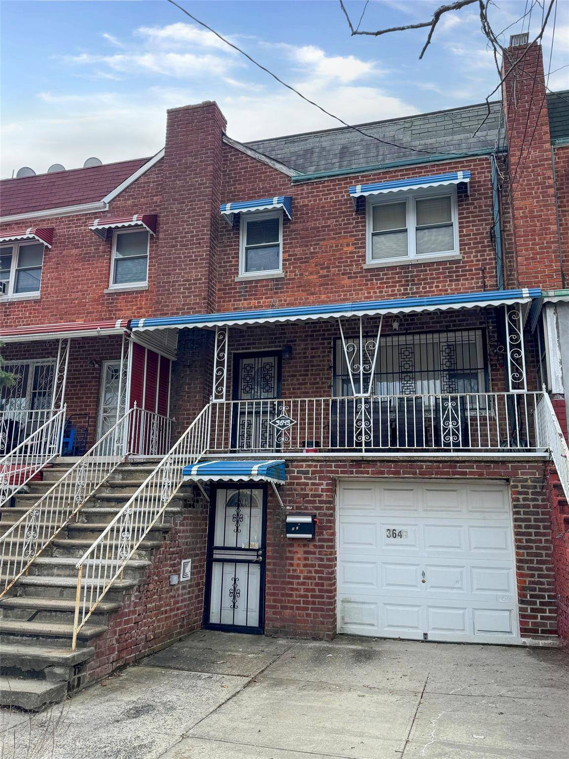 This is a 2 story attached 2 family brick home with an attached garage.