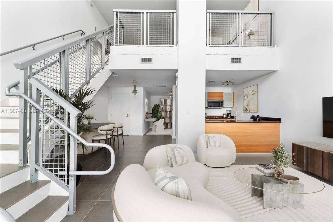 Welcome to Unit M0502 at Four Midtown Condo a true loft living experience with soaring 30 foot ceilings and expansive windows that bathe the space in natural light.