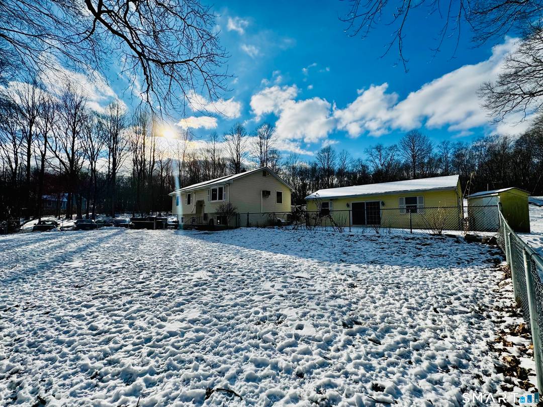 Welcome to this well maintained raised ranch, privately set back on a wooded lot in Ledyard, offering a peaceful and private setting with a thoughtfully designed, flexible layout.