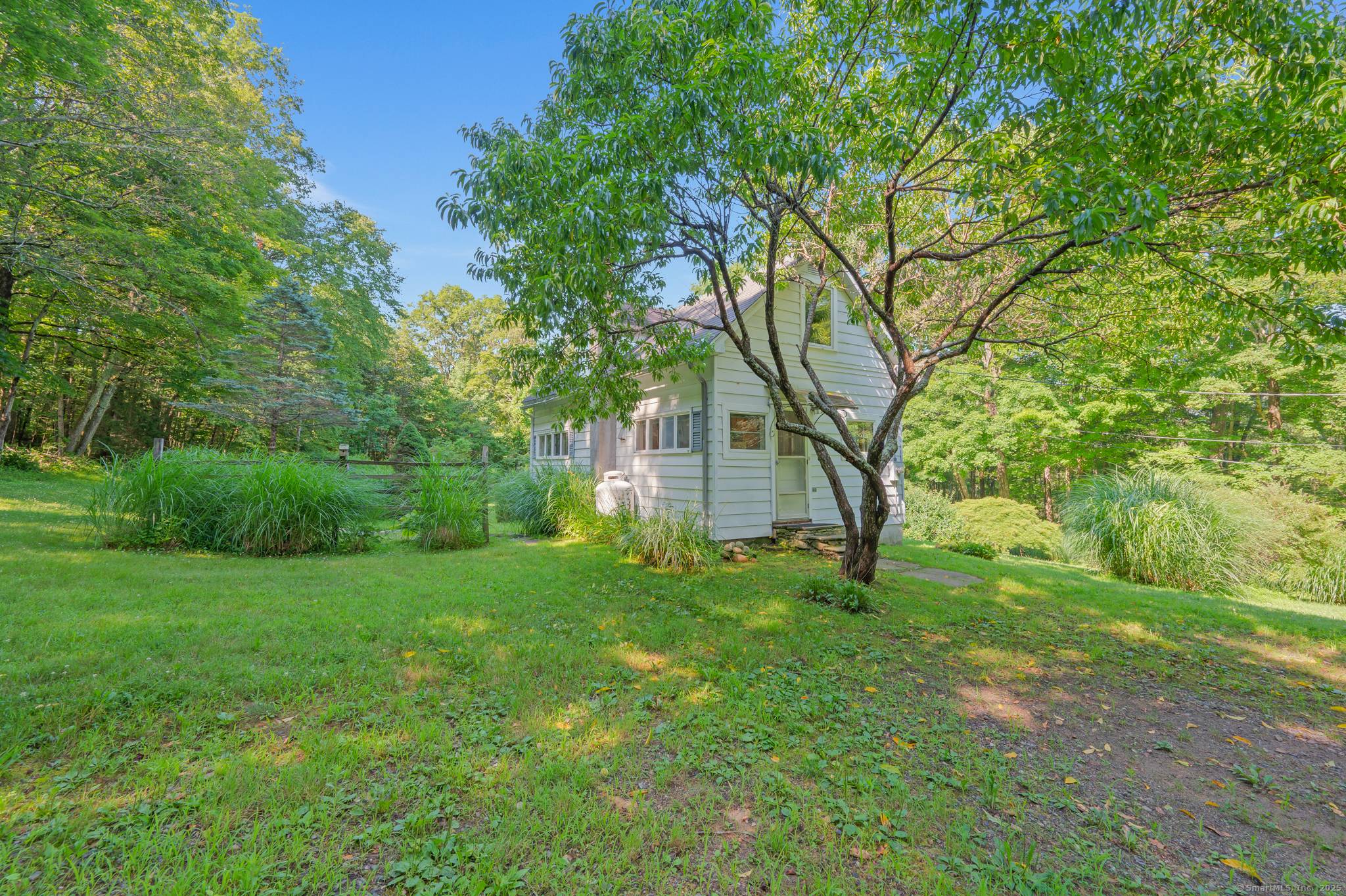 Private and charming 2 bedroom Country Cape located on 2 very pretty acres of private and landscaped property.