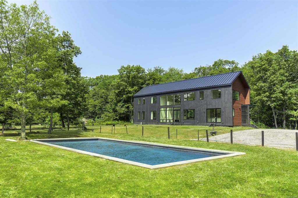 The approach to this spectacular contemporary barn style home takes you up a long, winding private driveway past open fields amp ; woods that are part of this special 22 ...