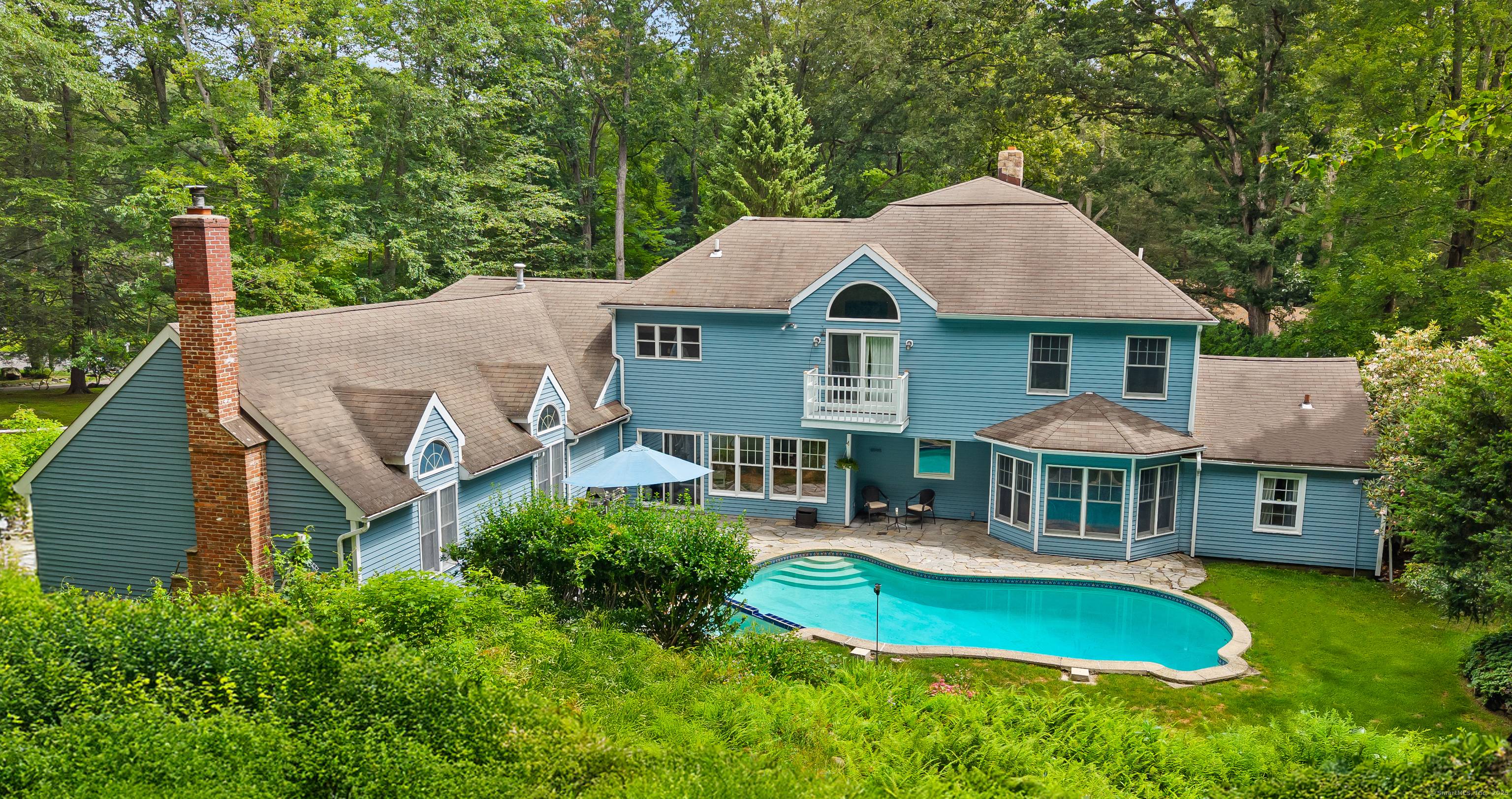 Live your best life at 60 Redmont Road, situated on the North side of Stamford, offering over an acre of land with complete privacy.