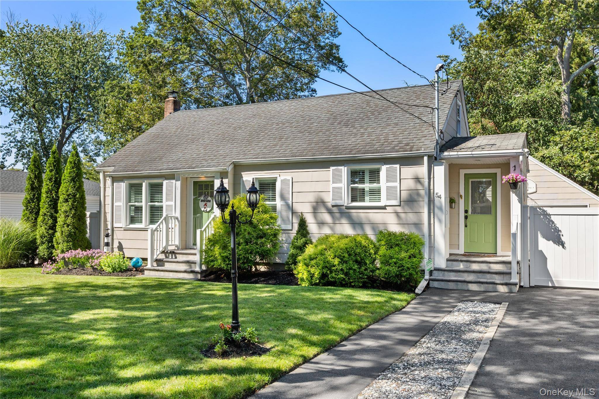 Welcome to 54 Rowland Street, nestled in the desirable Canaan Lake area of Patchogue.