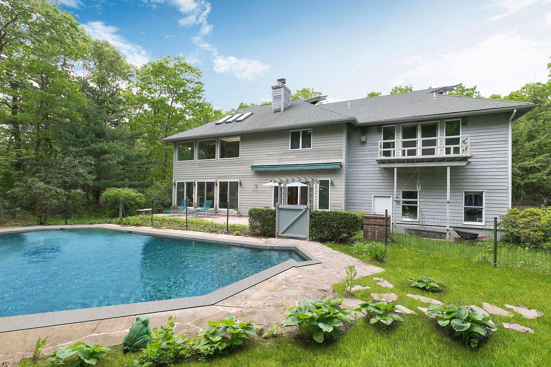 This Fantastic East Hampton home is located on a wonderfully quiet and secluded street in the Northwest Woods on two acres.