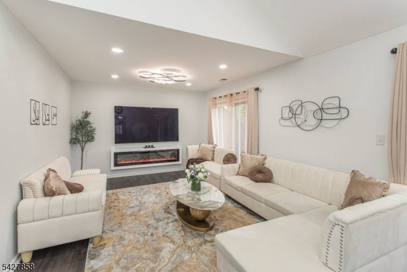 Welcome to this beautifully maintained, move in ready contemporary end unit townhouse in the highly desirable Atrium community of Parsippany Township, set in a serene, park like setting.