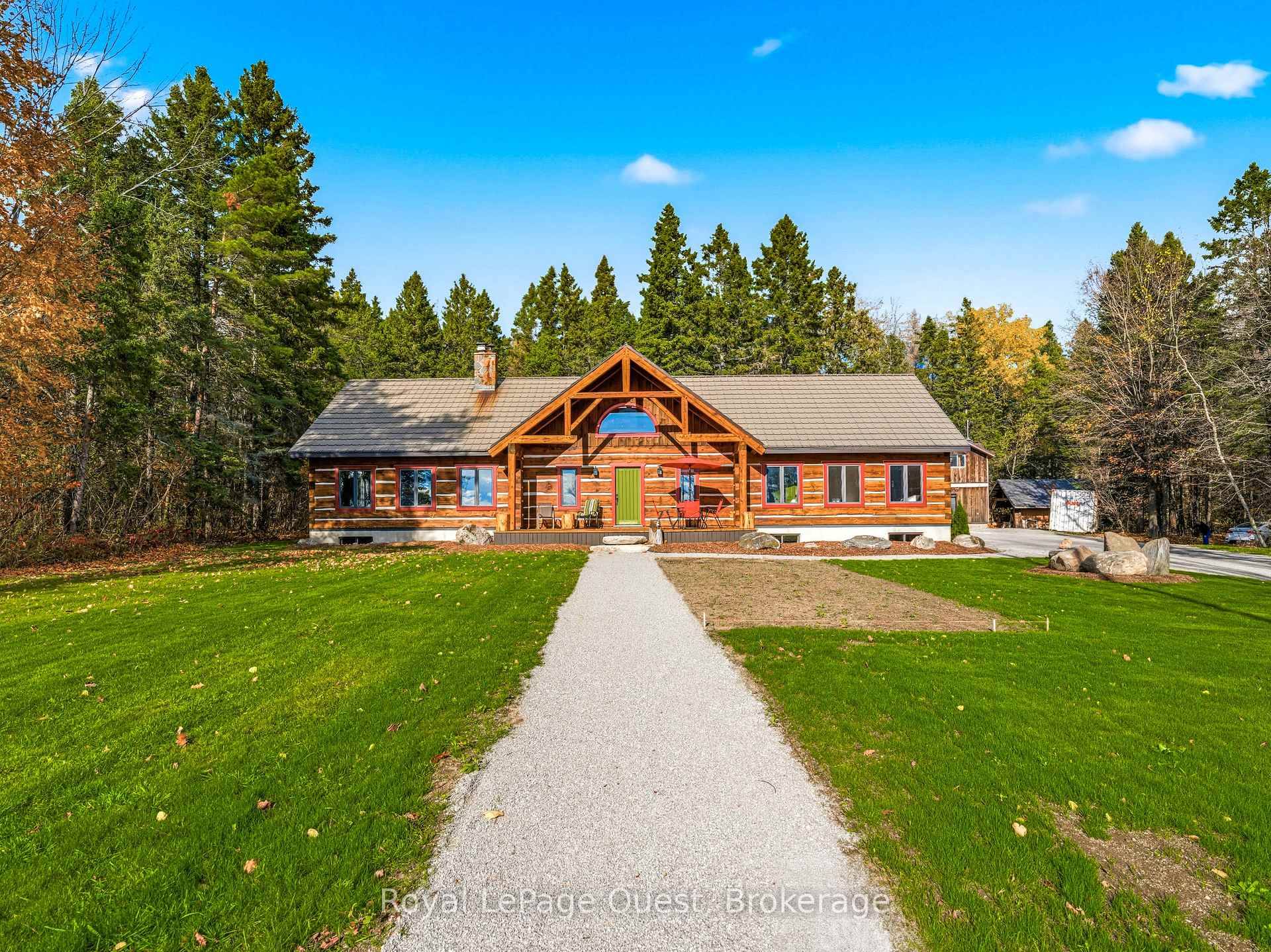 Custom home on 50. 6 acres with stunning views of Georgian Bay, farm land, and Blue Mountain seen from the living room, primary bedroom, and covered porch.