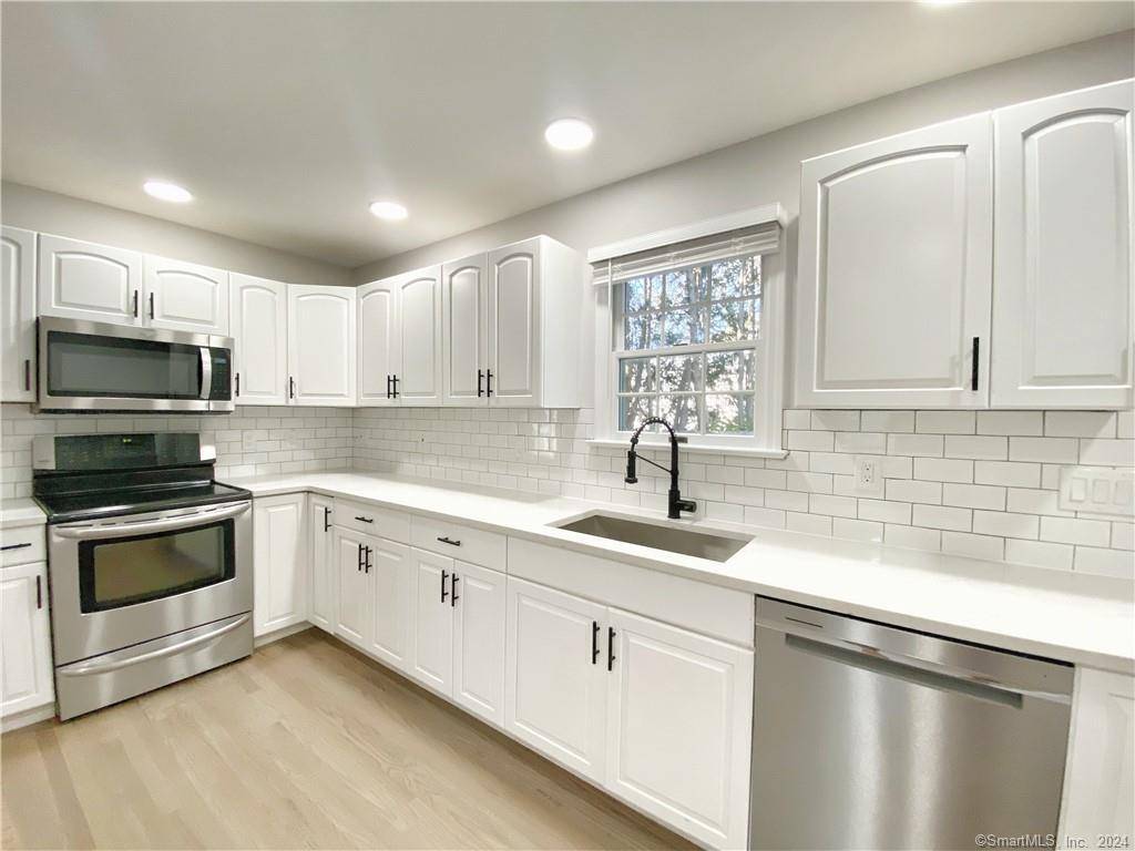 Updated 4 bedroom, 1. 5 bath townhouse with quartz counters and stainless steel appliances !