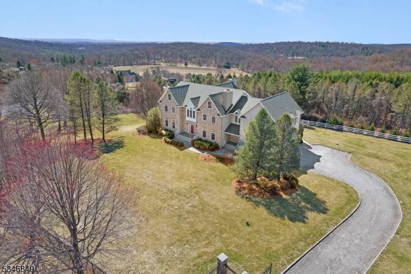 Impressive Colonial with stone front and Hardie Plank siding is set back beautifully on a private 5.