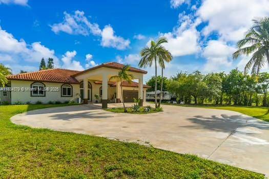 This impressive corner lot property welcomes you with a spectacular driveway and a majestic front entrance that immediately sets it apart.