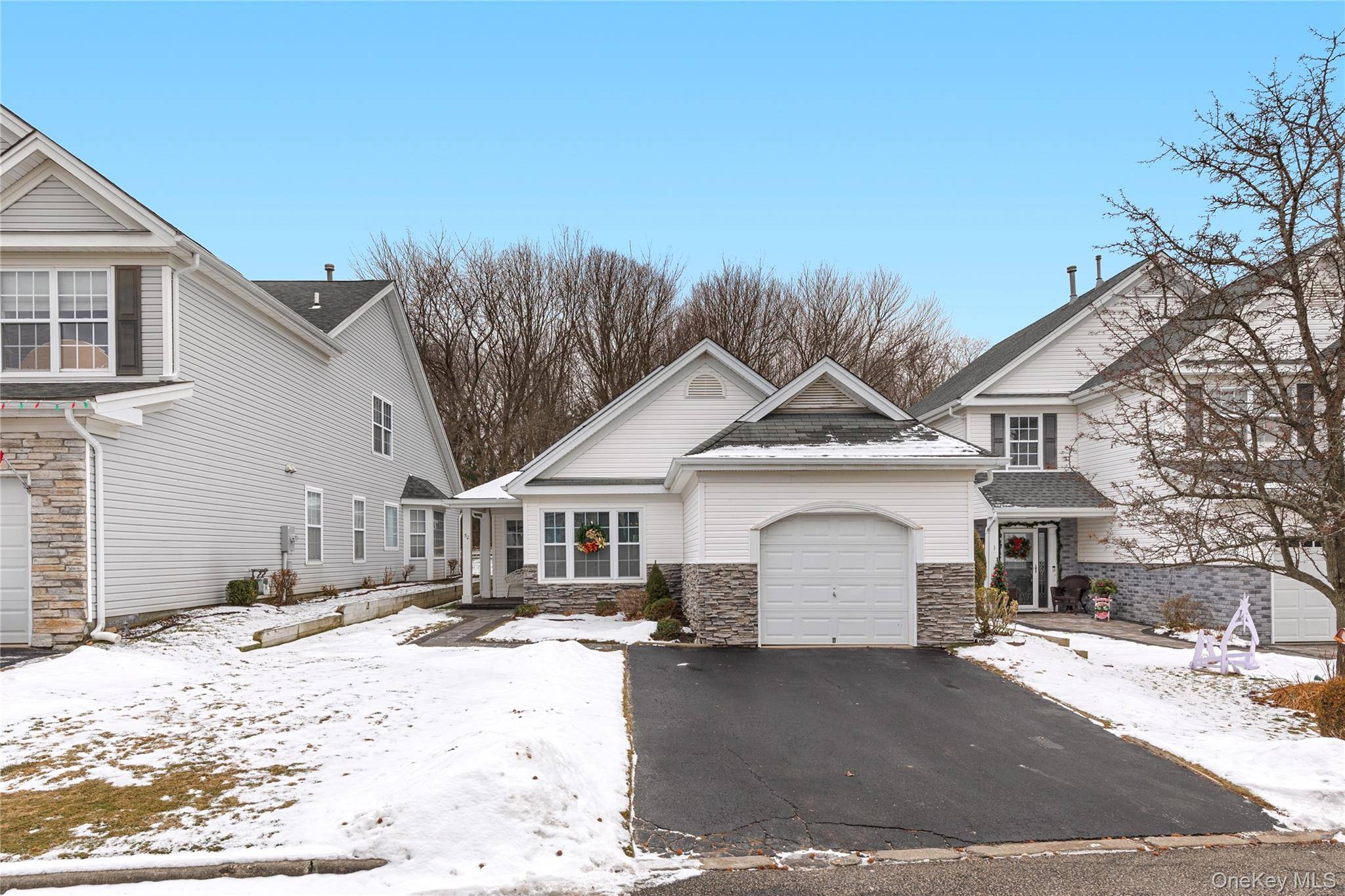 Welcome to 50 Perri Circle, a well maintained residence located within a gated community with 24 hour security in Middle Island.