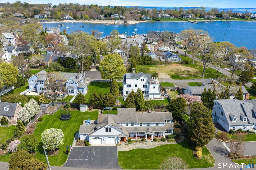 LIVE THE PERPETUAL VACATION LIFE IN NOROTON BAY Experience this chic, sun drenched Beach Colonial, perfectly situated on an open double lot.