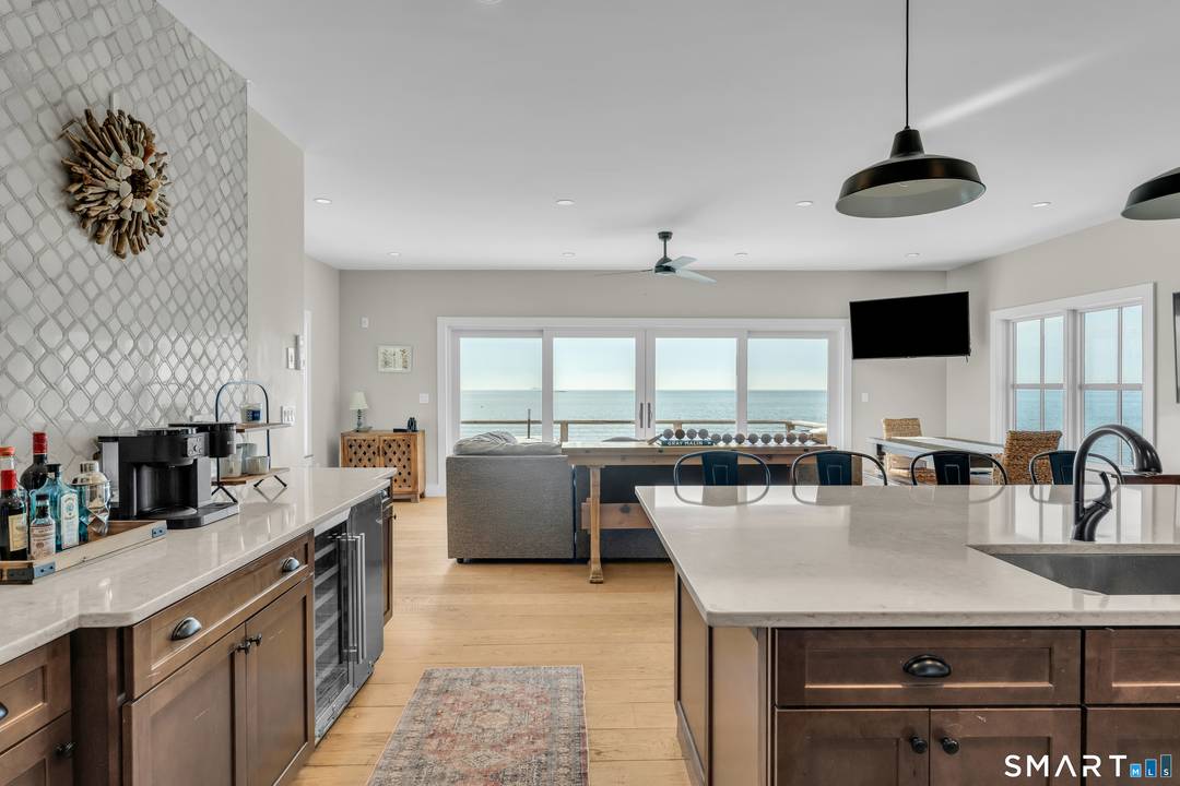 Panoramic vistas of Long Island Sound and the East River create a breathtaking backdrop for this sophisticated Madison waterfront retreat.