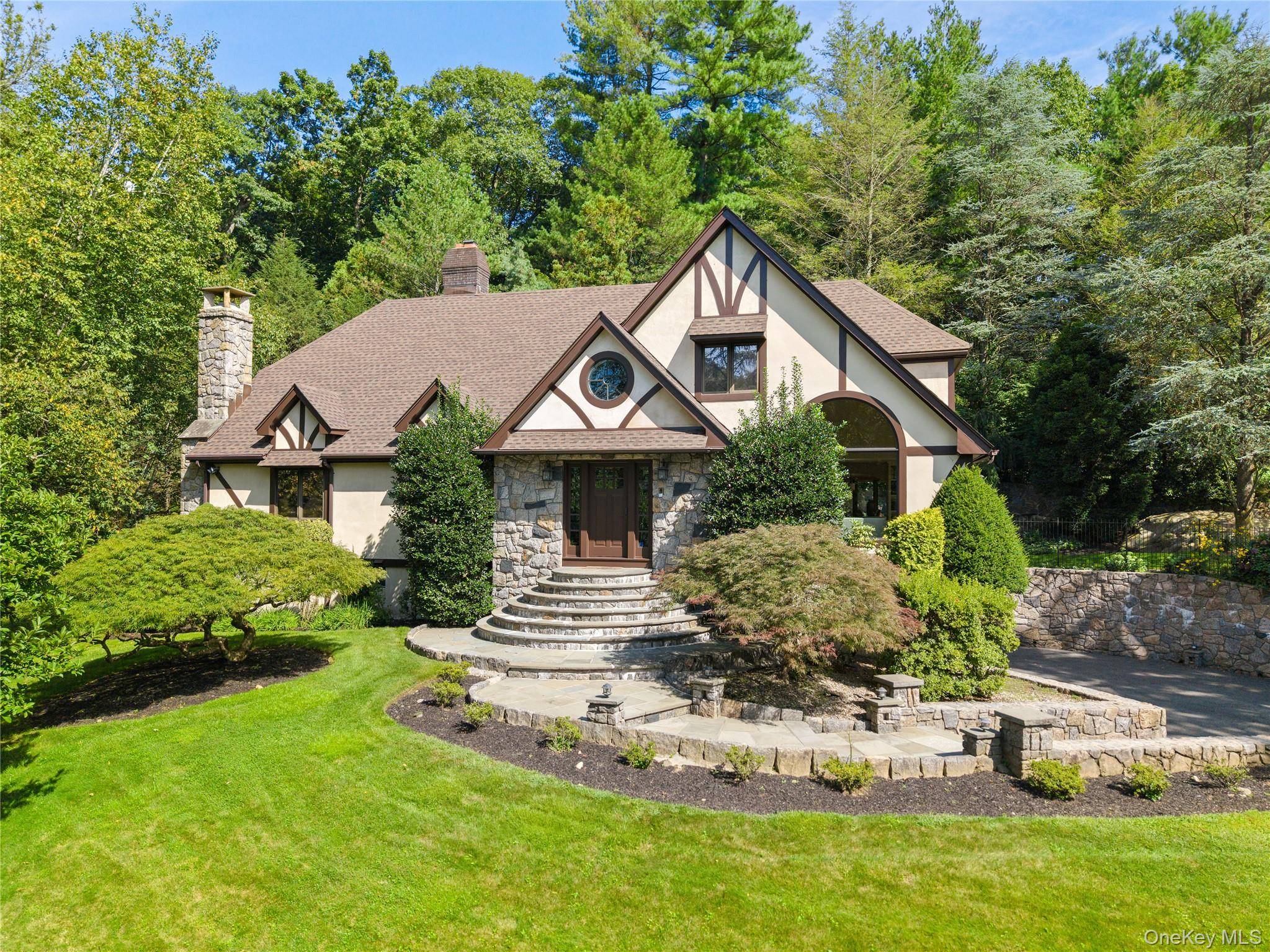 Blending timeless Tudor architecture with Scandinavian elegance, this luxurious residence offers a modern simplicity and country club living.