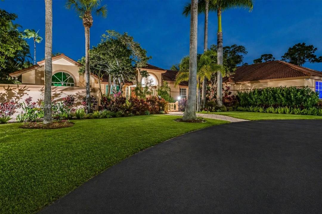Experience luxury lakefront living in this extraordinary custom estate located within one of Coral Springs most exclusive gated communities.