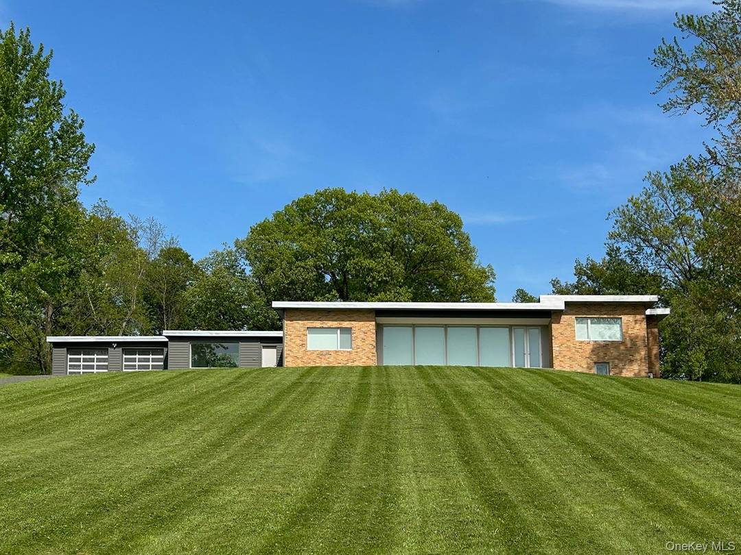 Enjoy this beautiful mid century home high on a hill with expansive Catskill views, 10 minutes to Hudson, now available year round.