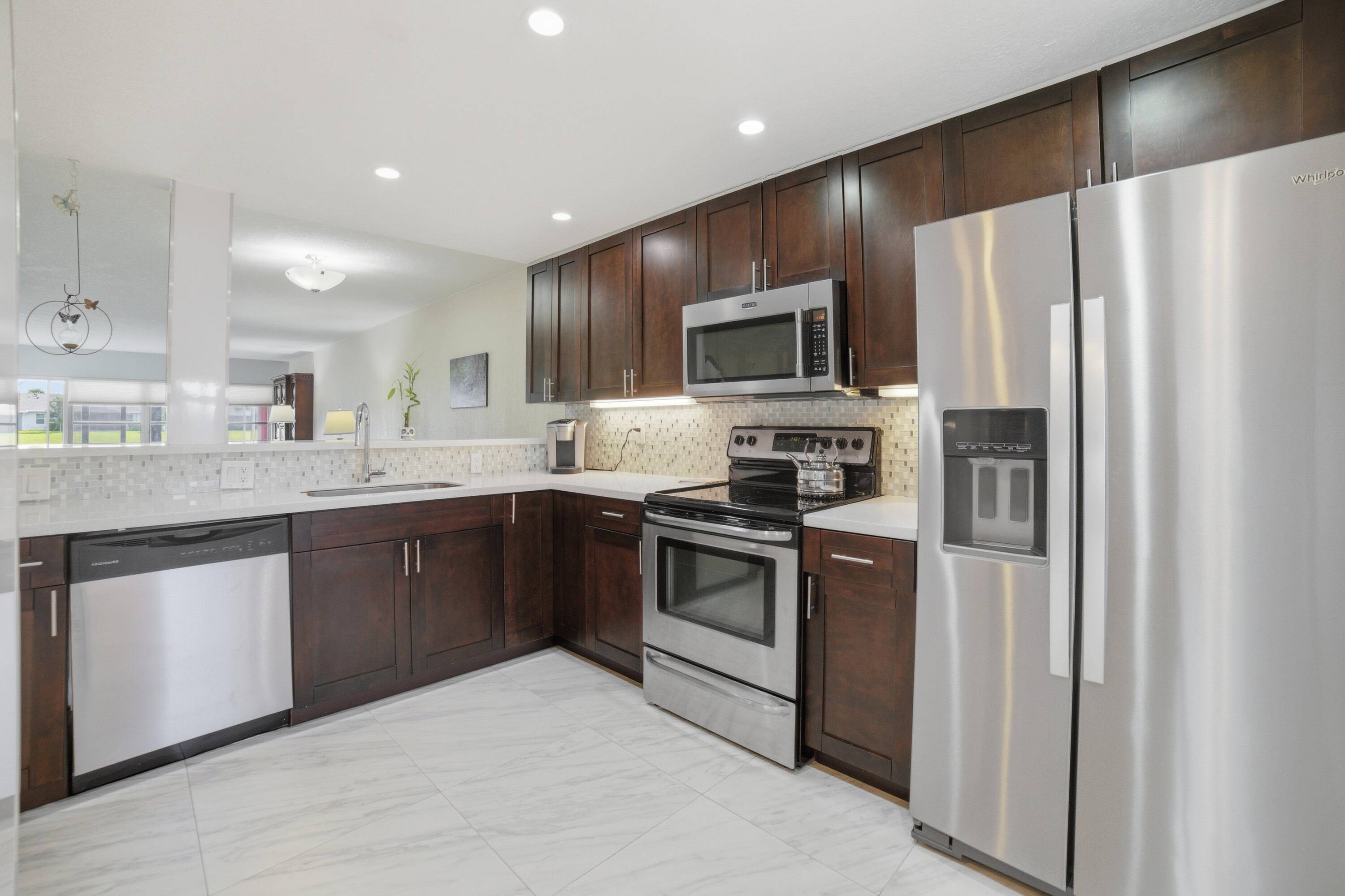 Renovated Corner First Floor condo in the 55 community of Palm Greens in Delray Beach.