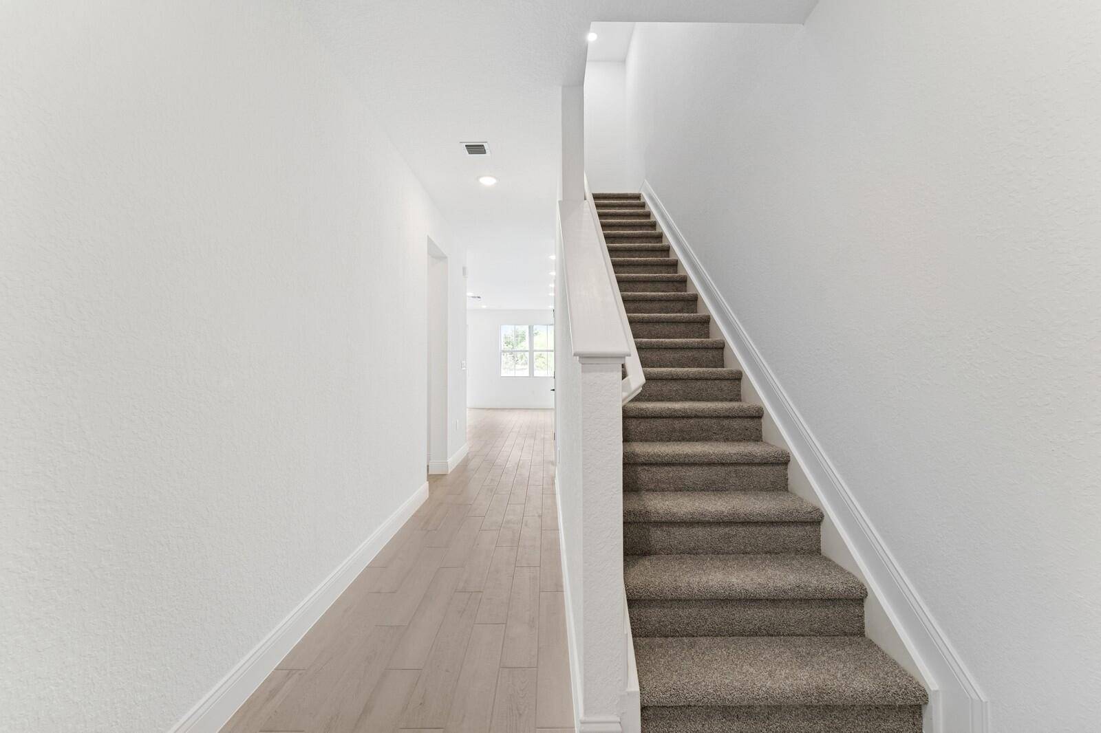 The Arabella II at Salerno Reserve Townhomes offers a gourmet kitchen featuring designer cabinetry and a center island, perfectly suited for meal prep and entertaining.