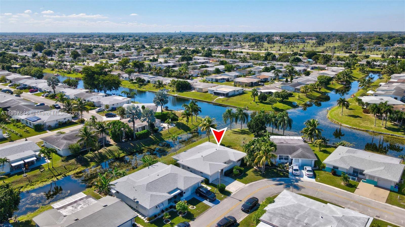 Gorgeous home situated on a corner lot with a lovely water view offers a combination of comfort and location in the coveted neighborhood of Paradise Gardens.