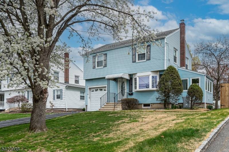CHARMING COLONIAL NESTLED IN A PEACEFUL RIDGEWOOD ACRES NEIGHBORHOOD.