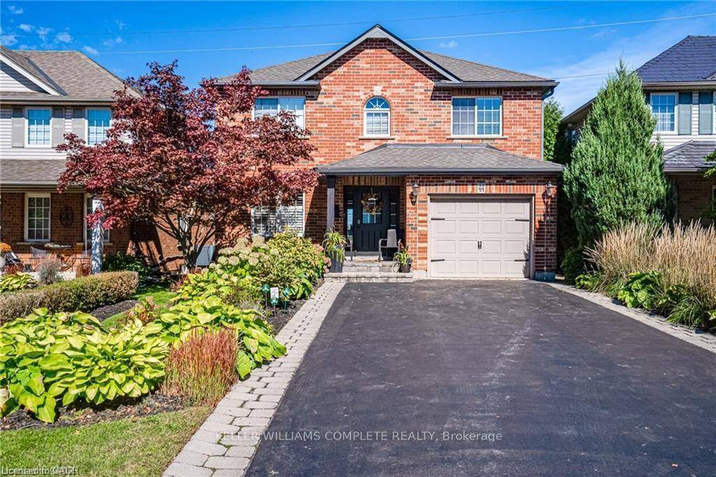 Welcome to 44 Grassyplain Drive, a charming red brick home with great curb appeal and beautiful, award winning gardens.