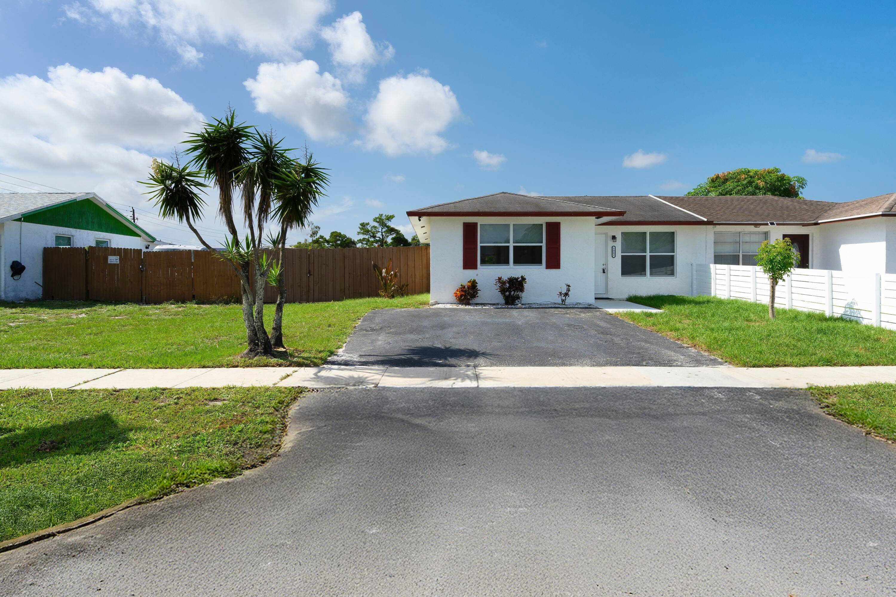 Beautifully remodeled villa featuring hurricane impact windows, brand new floors, and fully updated kitchen and bathrooms.