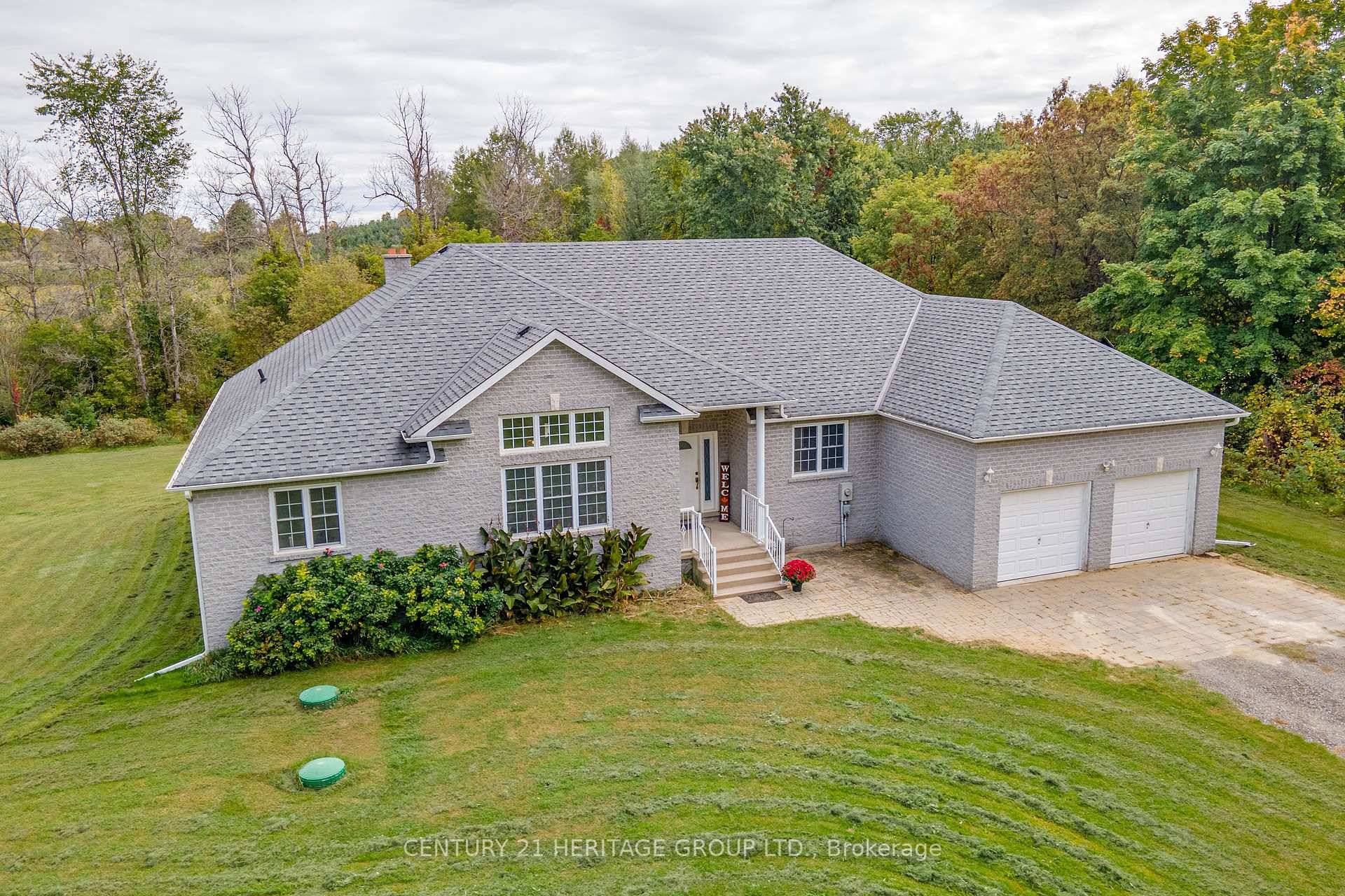Located on over 11 acres of welcoming landscape that features trails, wooded sections, and picturesque views, this custom built, all brick bungalow has been carefully maintained by its original owners, ...