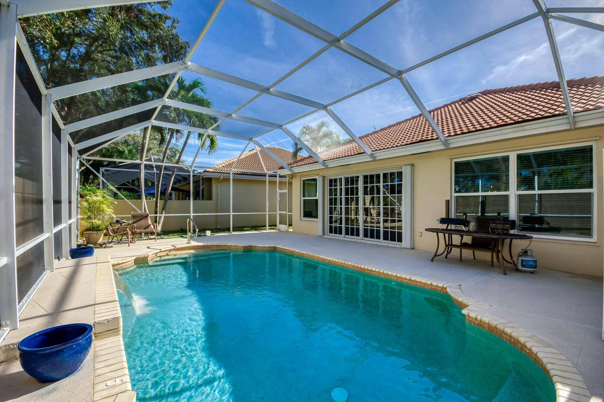 Enjoy the Florida lifestyle in this lovely one story home in Hamptons at Maplewood, a sought after tree lined community in the heart of Jupiter.