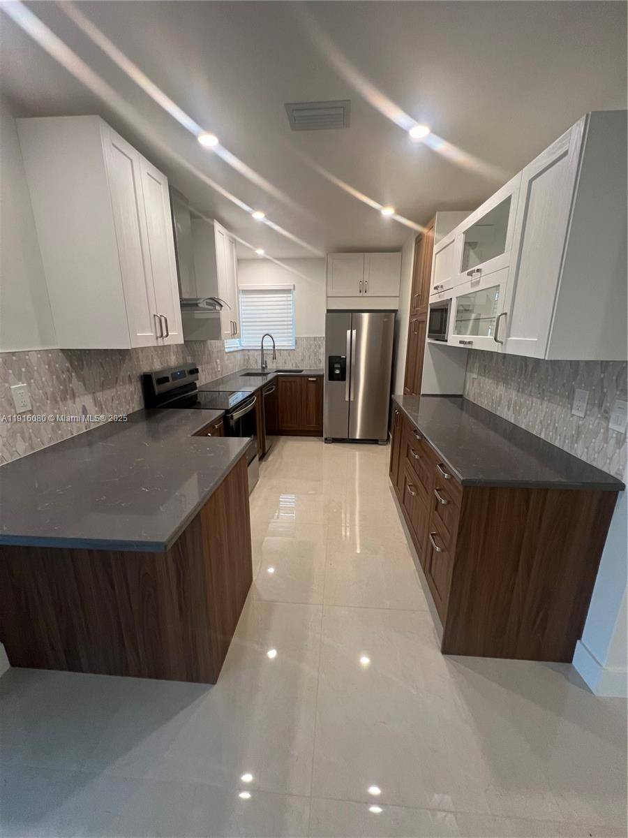 Stunning fully renovated, turn key corner lot home in prime West Park !