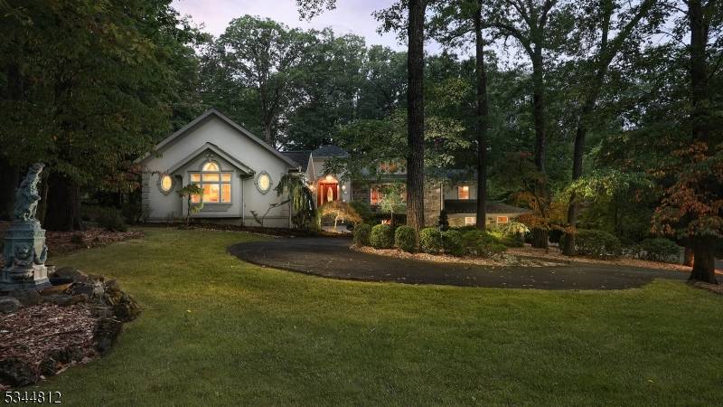 Custom stone and stucco Ranch set on a private wooded lot backing to golf course in the desirable Watchung community.