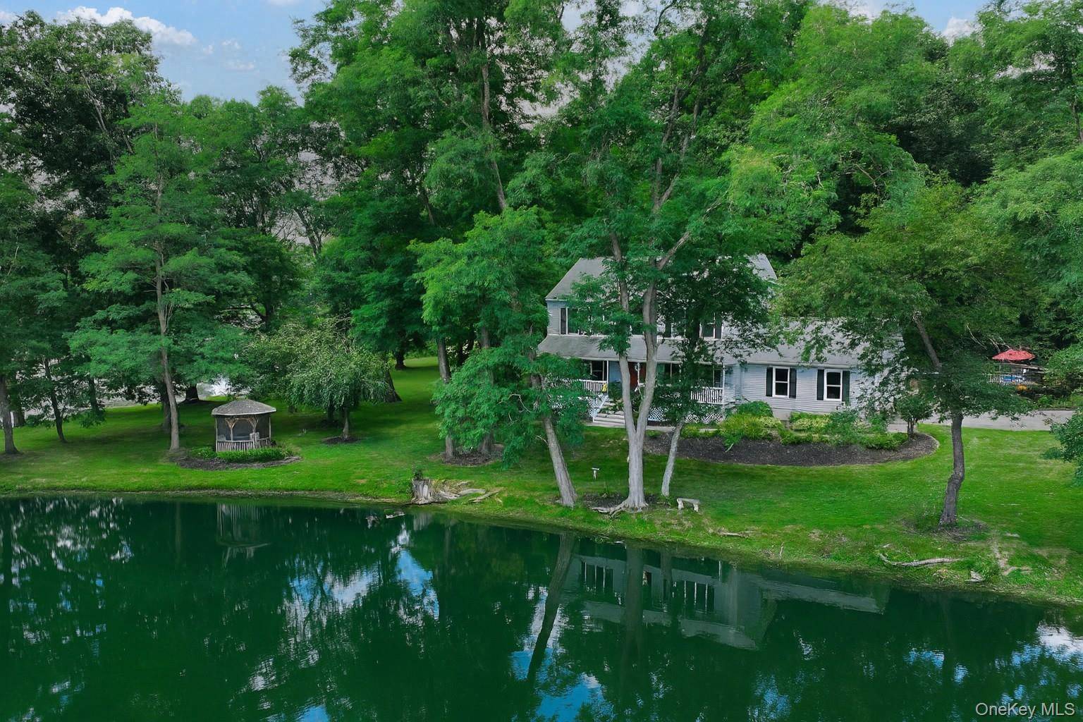 Live in resort style luxury year round in this exceptional 3, 500 sq ft waterfront residence tucked away on 1.
