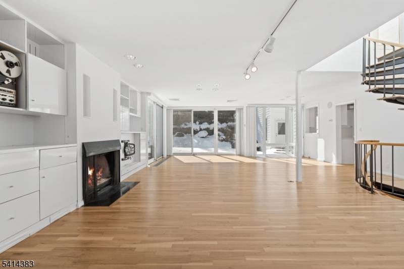 Expansive contemporary residence situated on a serene, wooded lot offering exceptional space, natural light, and a tranquil setting.