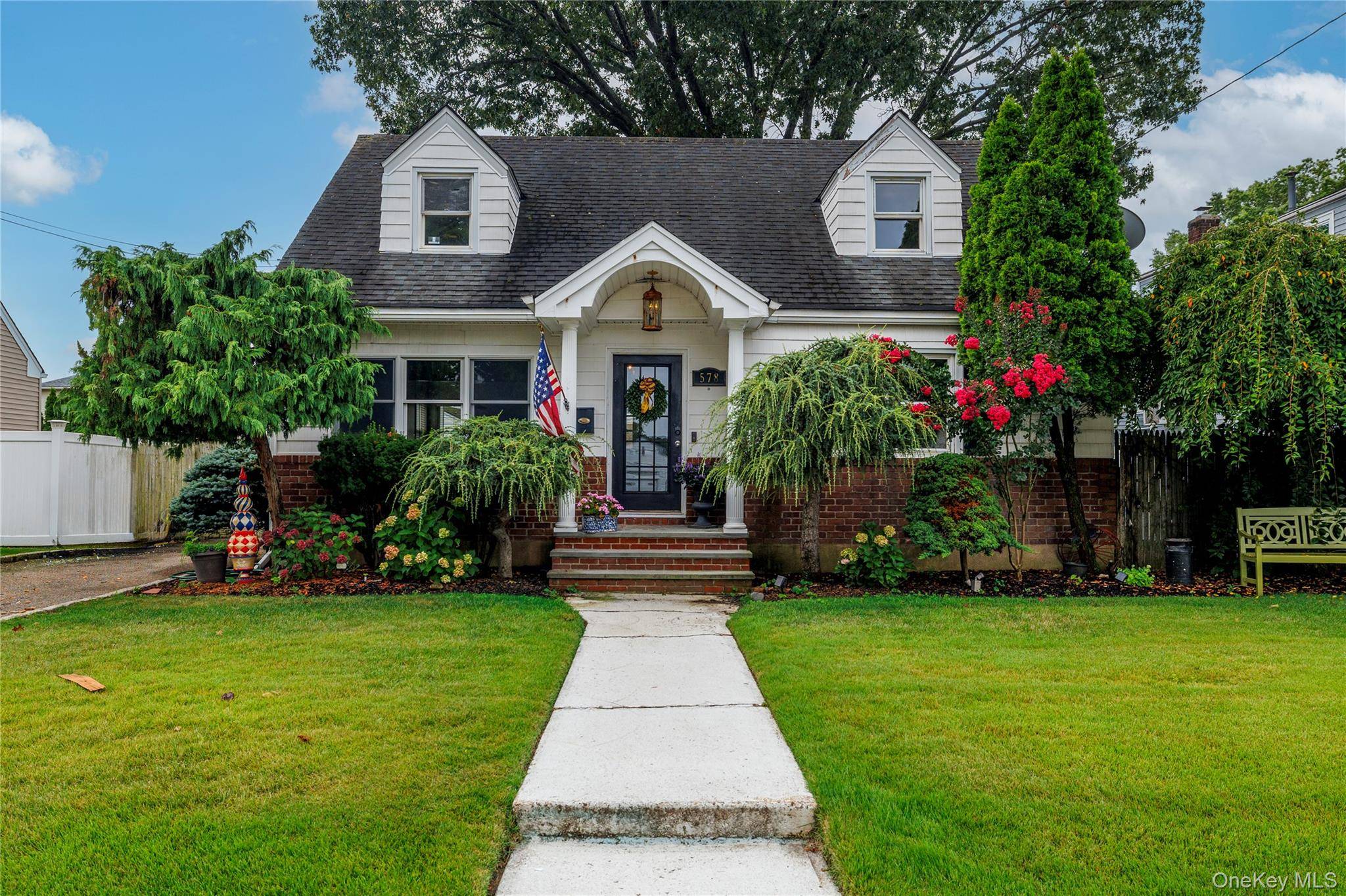 Lovely expanded Cape Cod home features 3 bedrooms and 2 full baths.