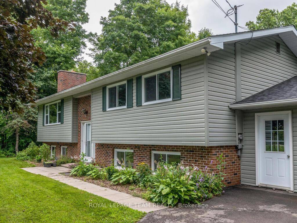 This Amazing fully renovated raised ranch bungalow sits on almost 3 acres of stunning property.