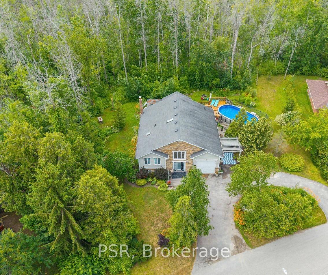 Discover the ultimate relaxation retreat in this beautifully upgraded raised bungalow, nestled on a nearly half acre landscaped lot with direct beach access just steps away.