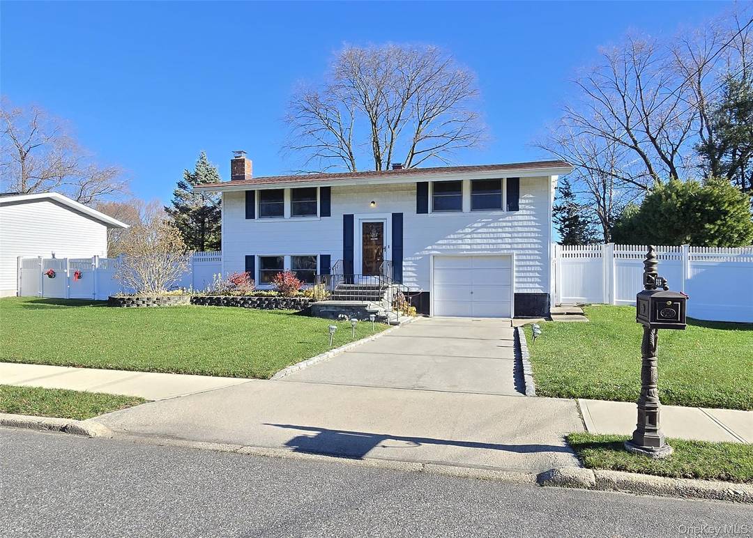 Step inside this warm and welcoming high ranch and feel right at home.