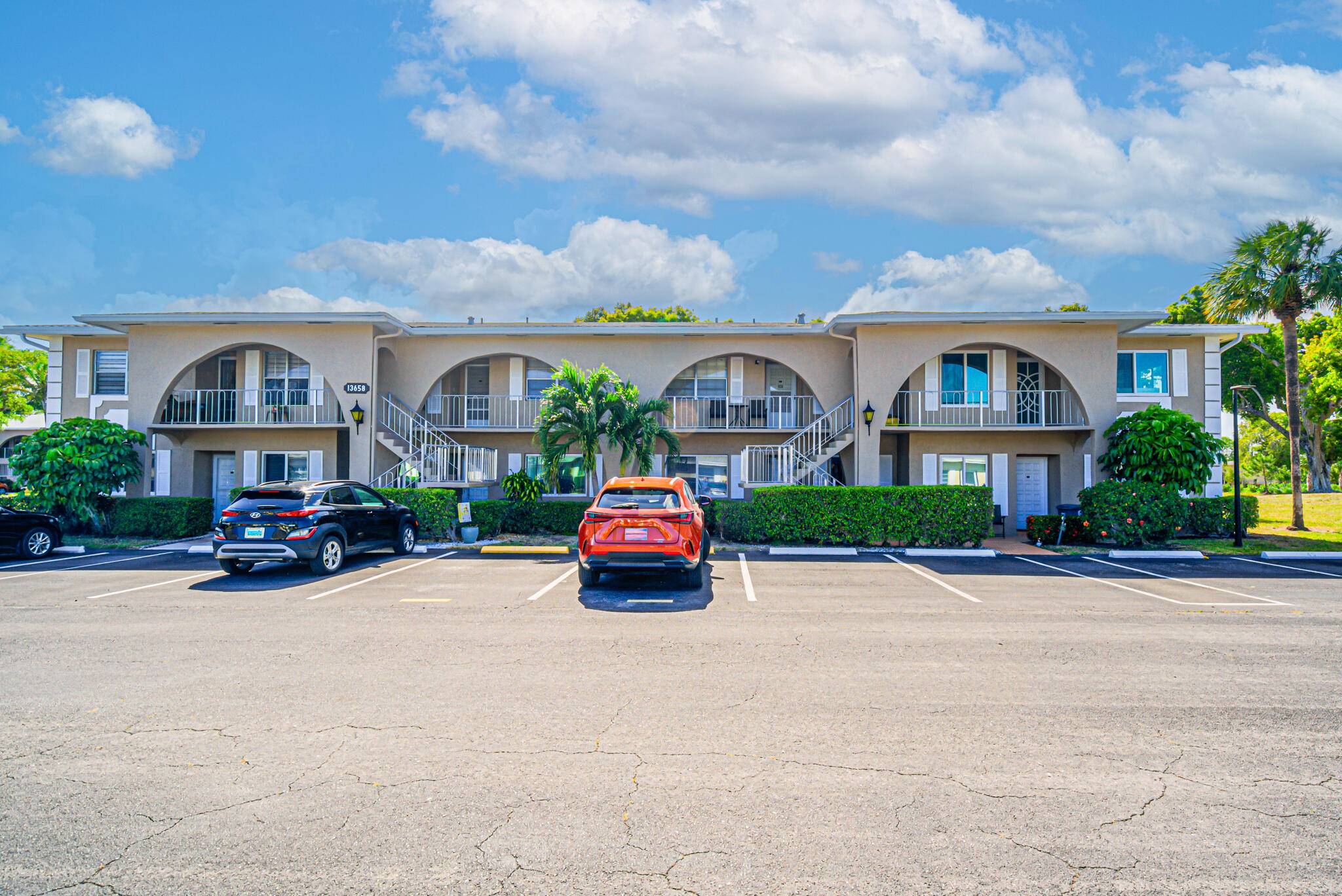 Come enjoy easy living in this beautifully updated 1st floor 2BR 2BA condo with hurricane impact windows and a back door leading to a spacious patio framed by majestic banyan ...