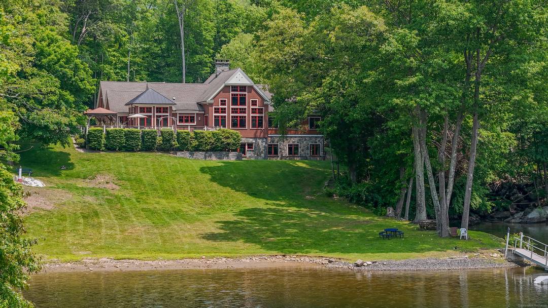 Grand post and beam home with level lake frontage and views, babbling brook, main level master suite, 9 car garage, finished walk out, and unfinished loft spaces for potential for ...