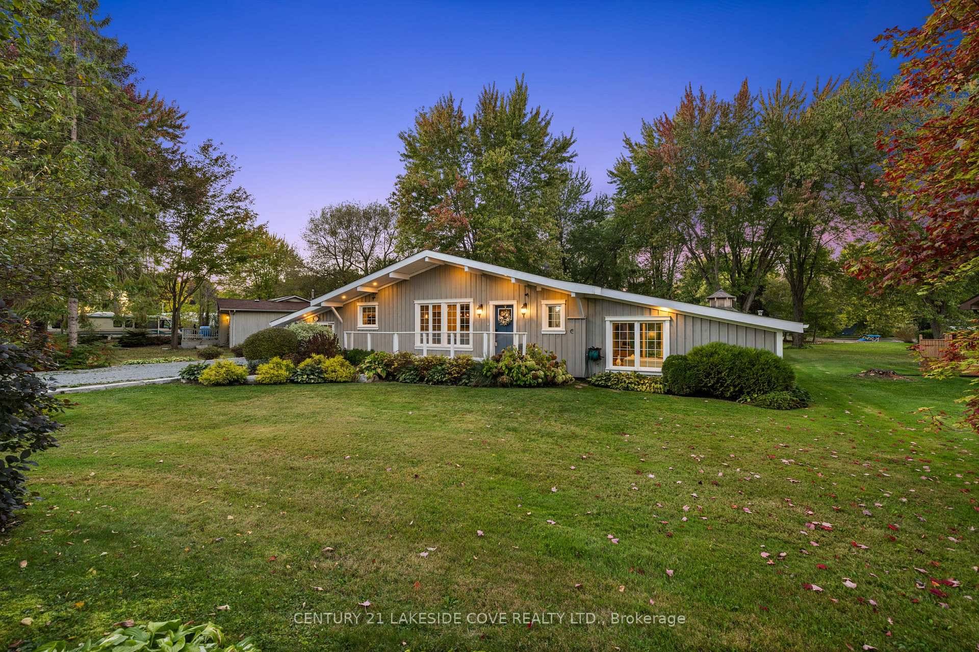 This Exquisite 3 bedroom, 2 bathroom Waterfront Bungalow is Nestled on Nearly Half an Acre of Beautifully Landscaped Grounds in the Highly Coveted Lagoon City Community.