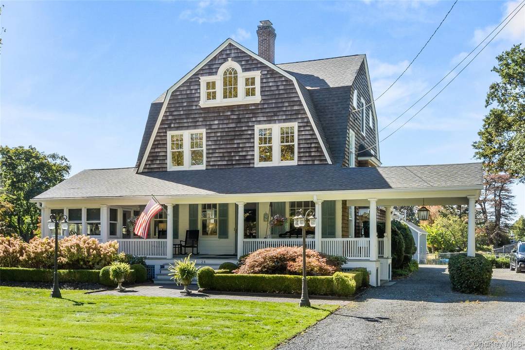 Welcome to 28 S. Montgomery Avenue a distinguished Dutch Colonial set on nearly an acre of waterfront property in Bay Shore.