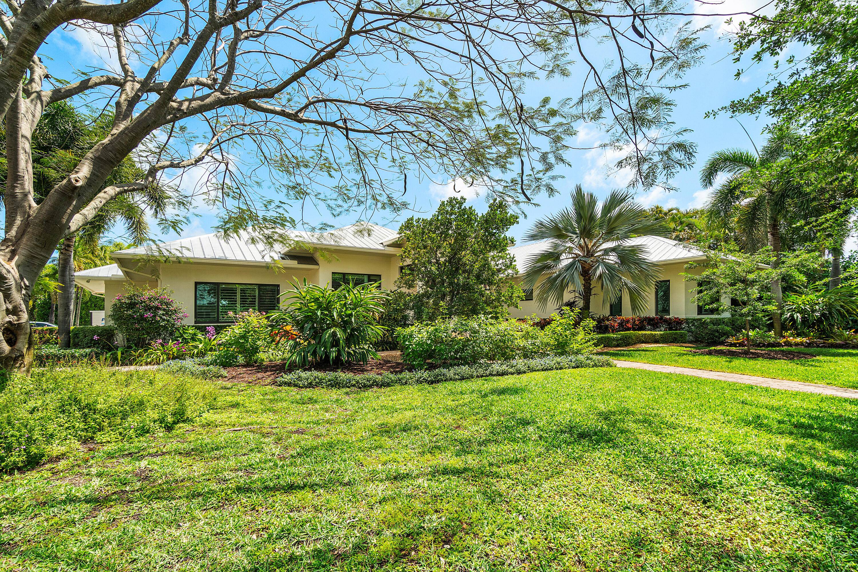 This custom coastal contemporary home is just 12 years old, situated on an oversized corner lot in the premier section of lake Ida, just 2 blocks from Lake Ida park.