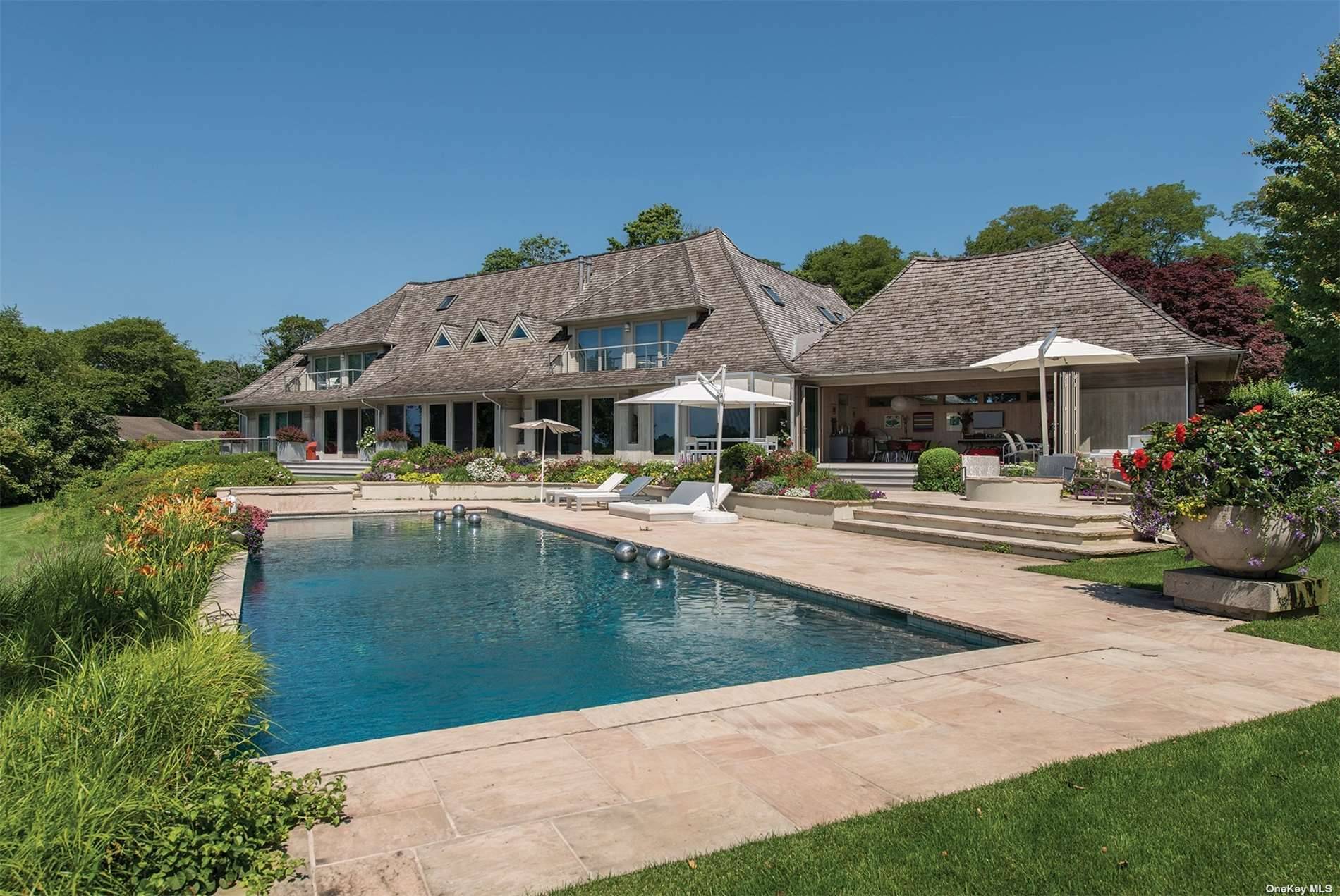 This custom built estate offers striking panoramic water views across Mill Pond with 700 feet of waterfront on 2 bucolic acres.