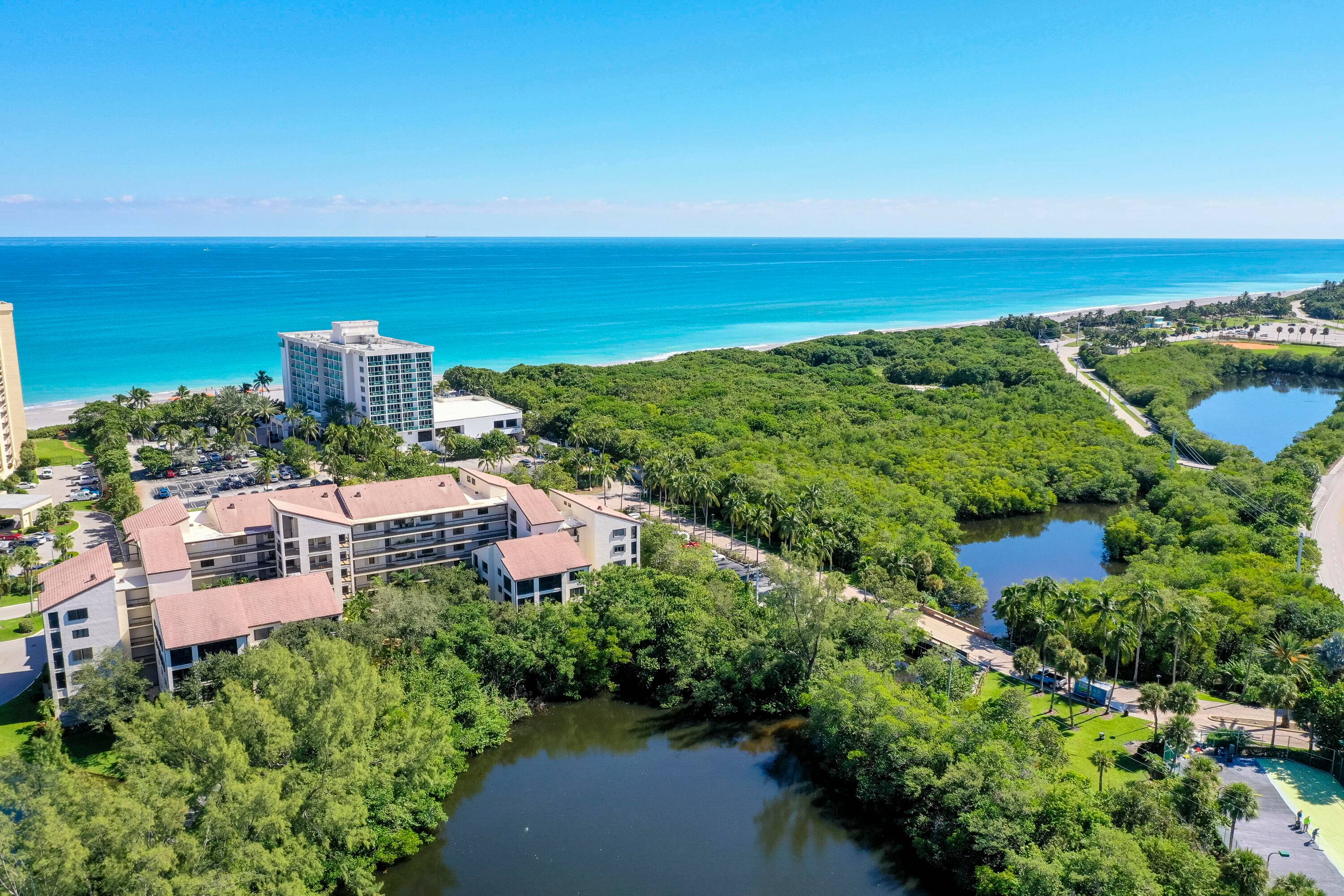 Large corner unit with a spacious screened lanai overlooking a lushly landscaped garden !