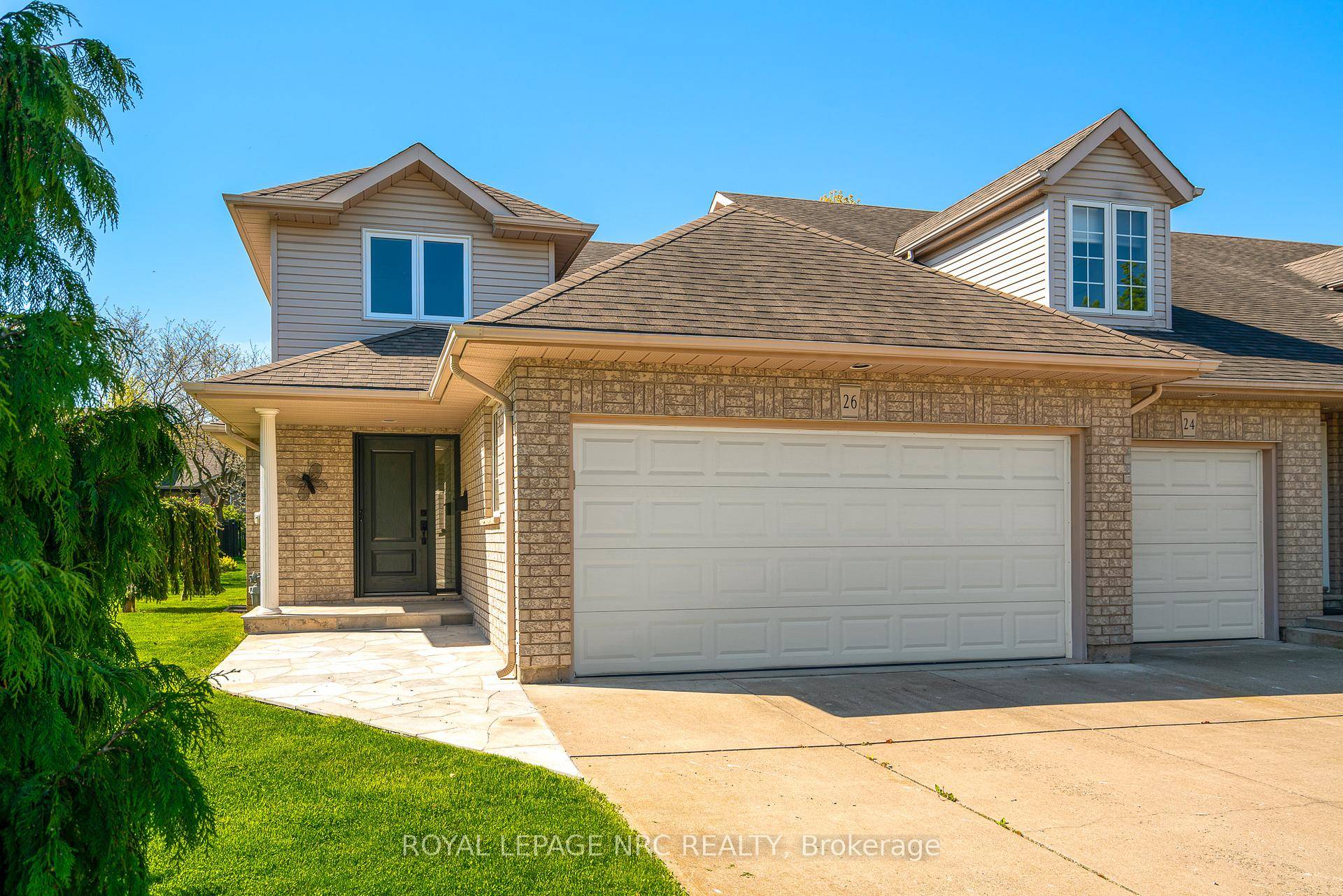 Beautifully maintained end unit freehold townhome with double garage nestled in a park like setting.