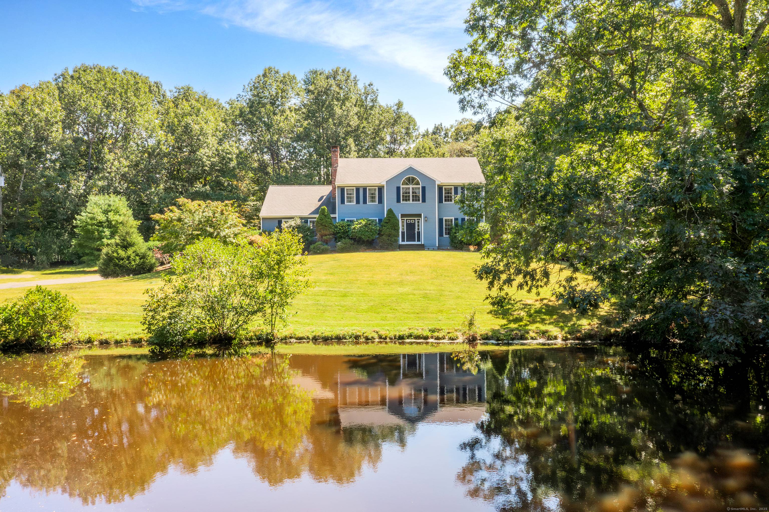 This custom built Colonial offers 4 bedrooms and 4 bathrooms, nestled on 3 serene, private acres with stunning pond views.
