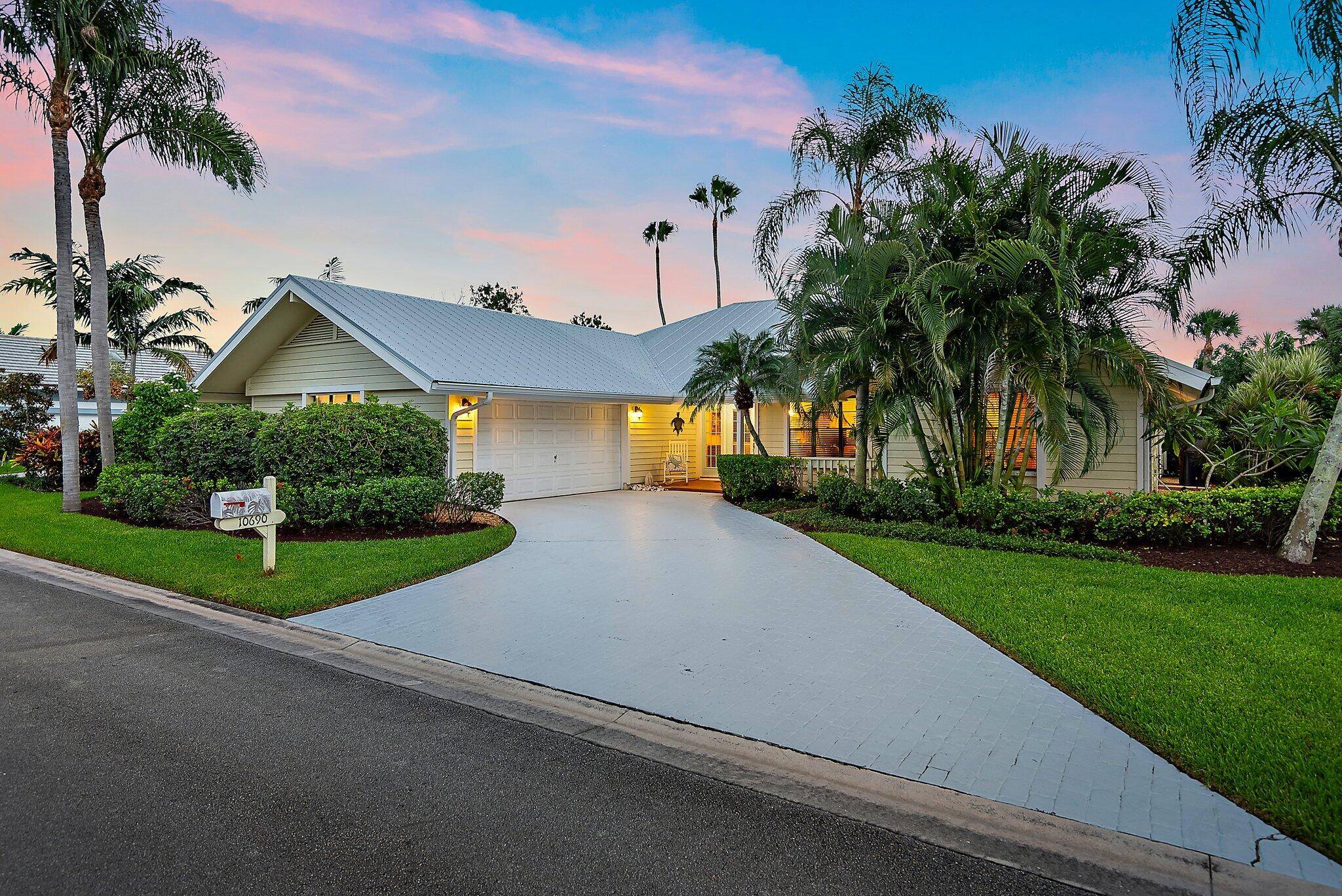 This charming Key West style residence features three bedrooms, two bathrooms, and a spacious two car garage.