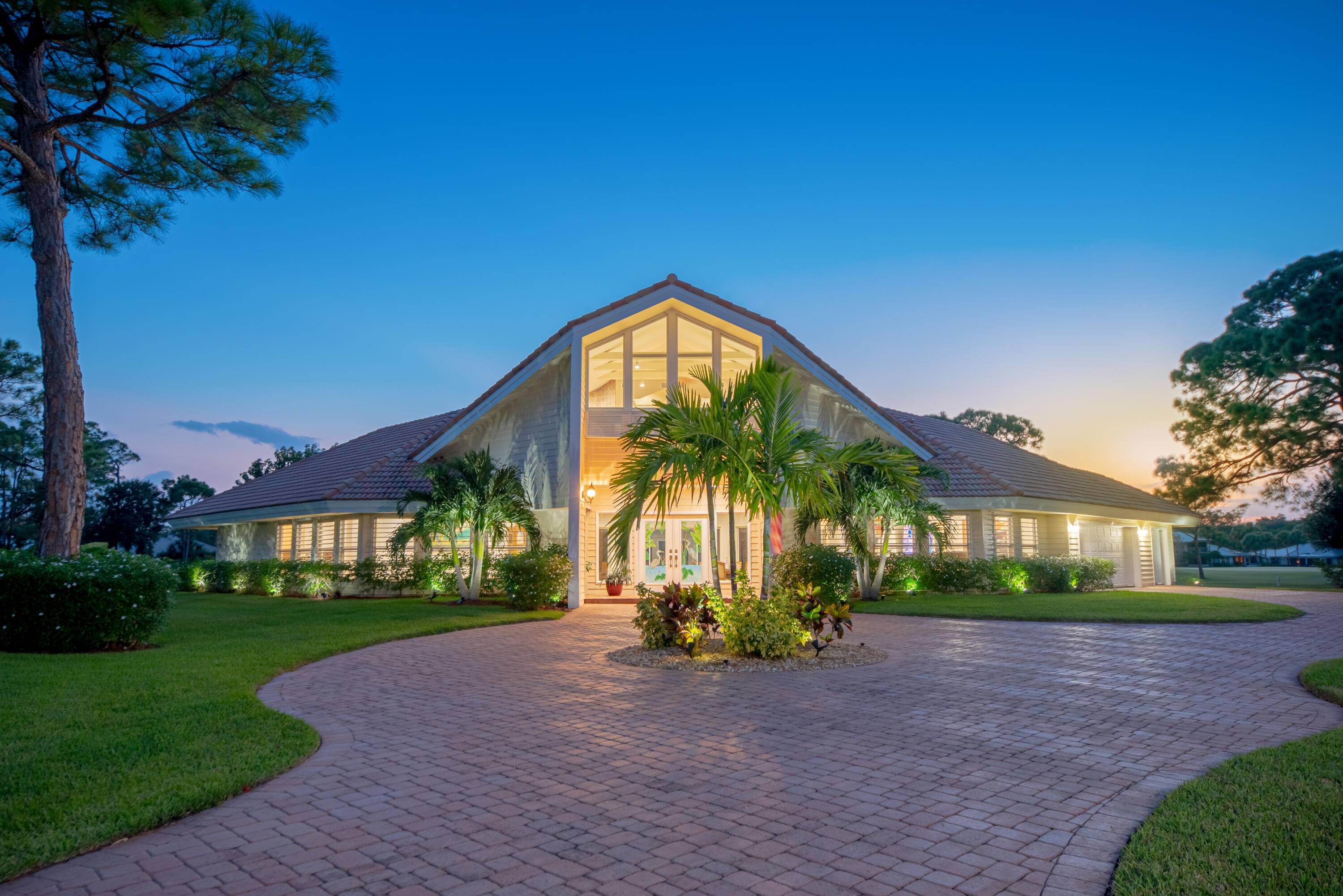 Experience modern elegance in this stunning home designed by world renowned architect Charles Stinson, located in the prestigious PGA Village.