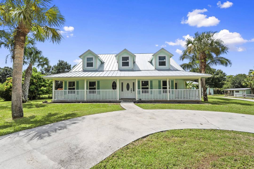 Discover the perfect blend of country charm and modern comfort in this Palm City Farms pool home on 4.