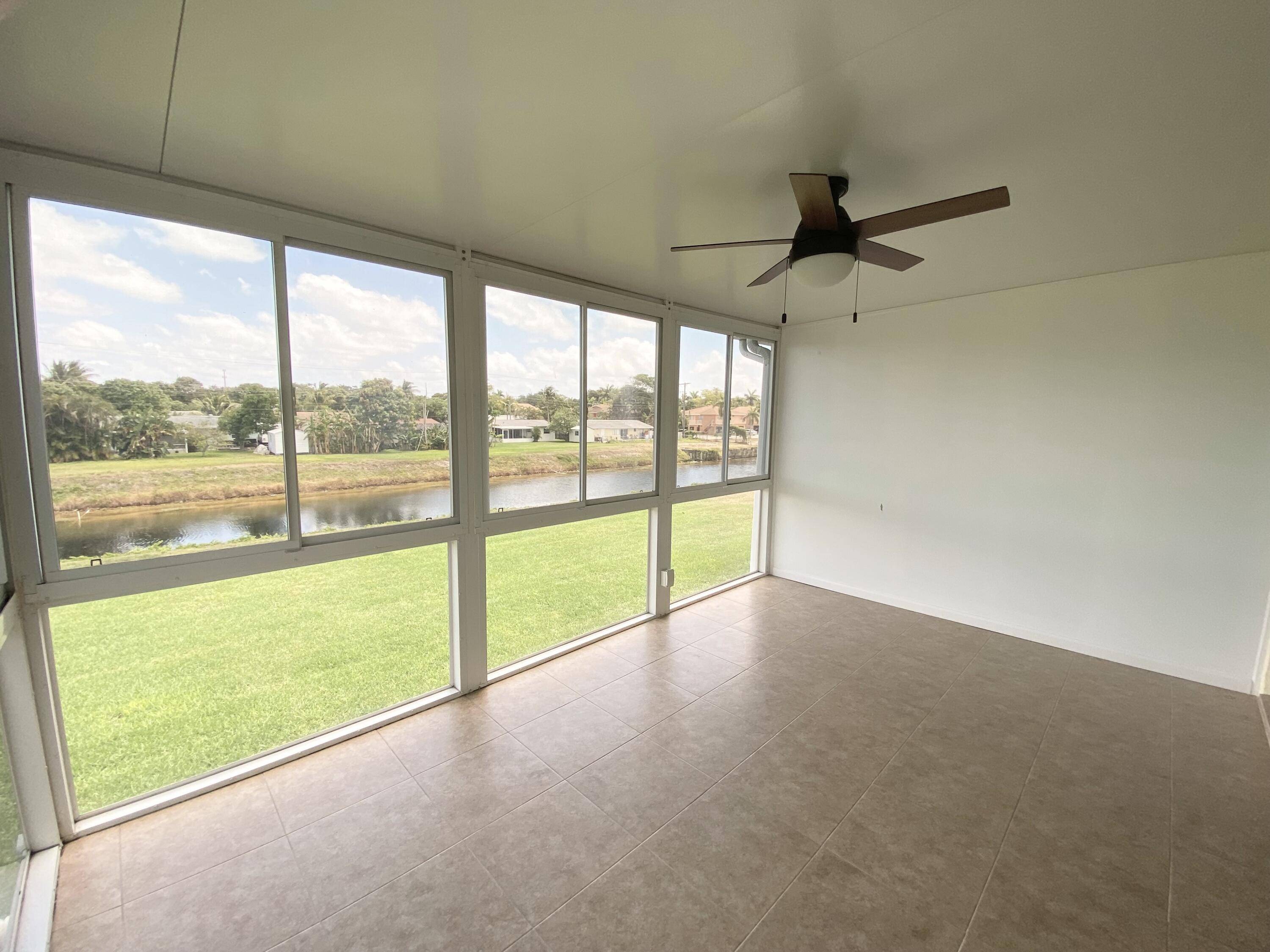 PINES OF DELRAY. This sharp looking 1167 sq ft 2 bedroom 2 bath canalfront residence boasts a remarkable additional 160 square feet of screened and windowed patio space, enhanced by ...